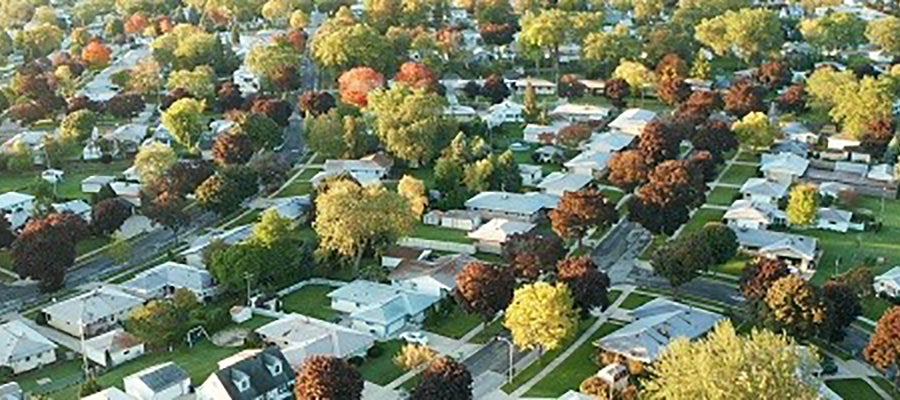 Investing in Community Health: A Discussion for Senior Hospital Leaders. An aerial photo of a suburban community.