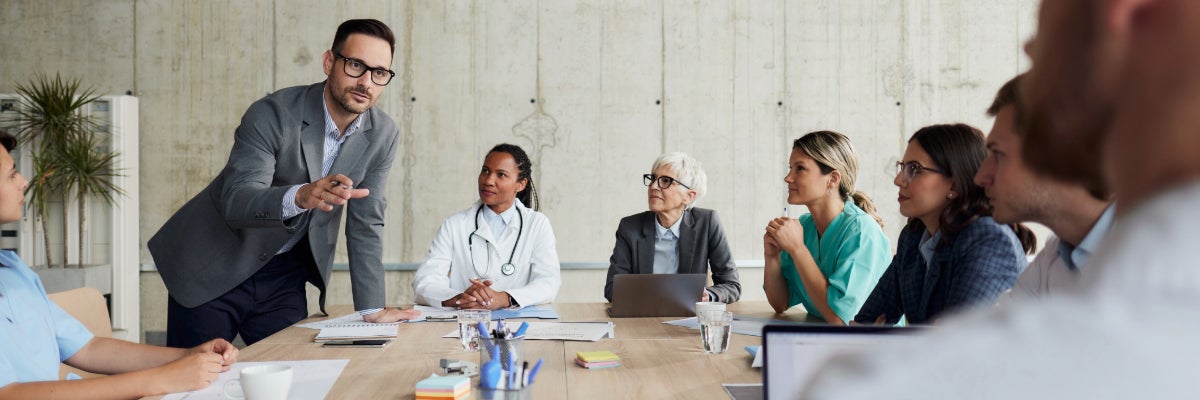 Group of business women and men in a meeting.