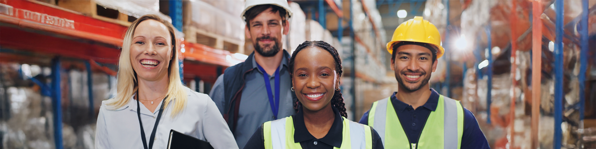 Supply Chain Professionals in the warehouse smiling and being friendly