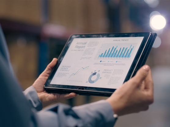 person holding tablet in a warehouse