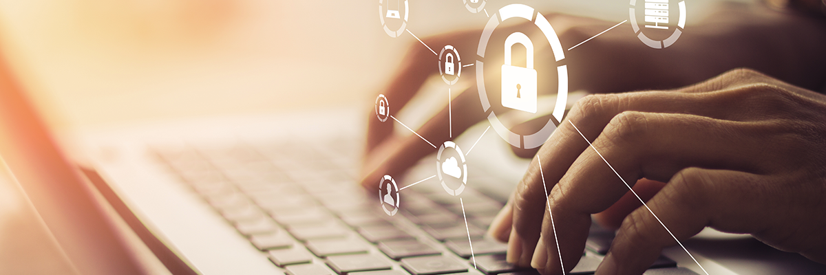 cybersecurity icons and person typing on laptop 